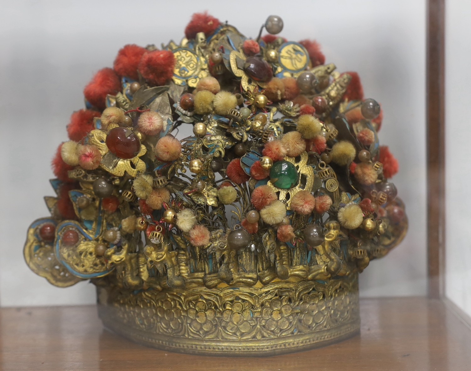 A Chinese gilt metal, kingfisher feather and glass mounted lady’s wedding headdress, late Qing dynasty, decorated with phoenixes